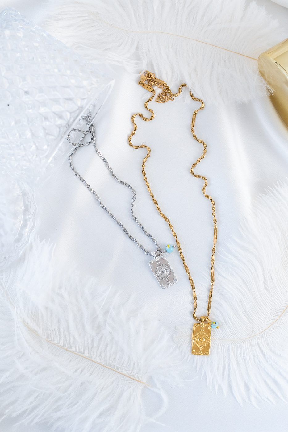 Gold necklace with evil eye protection tag