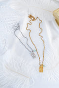 Gold necklace with evil eye protection tag